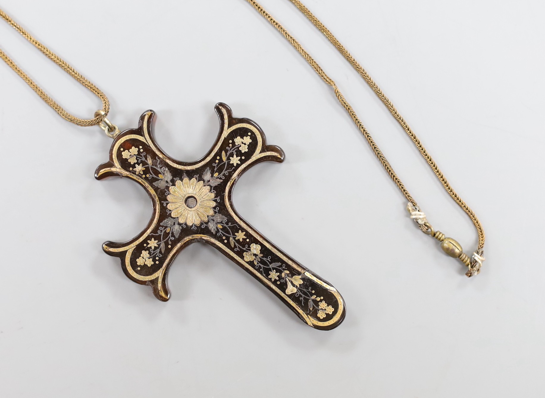 A Victorian tortoiseshell and yellow metal pique cross pendant, 73mm, on a gilt metal chain.